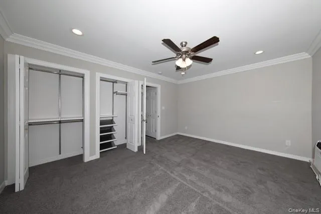 a view of an empty room with a ceiling fan