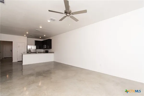 a view of kitchen with furniture and a ceiling fan