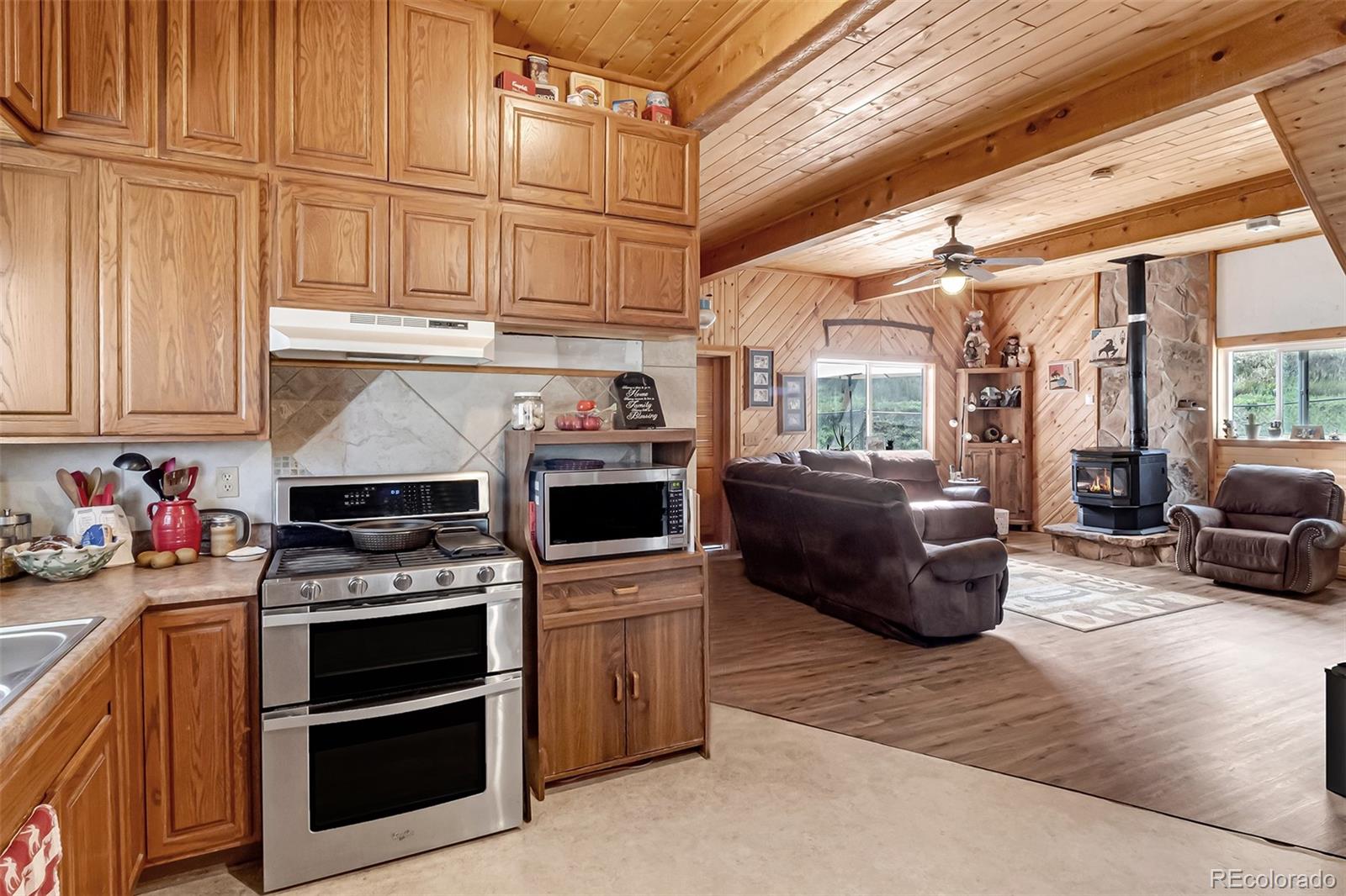 26101-246 16 1/10 Road Whitewater, CO 81527 - Photo 13 of 49 a kitchen with furniture a stove and a refrigerator