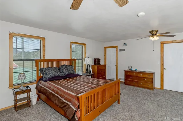a living room with furniture a couch and a ceiling fan