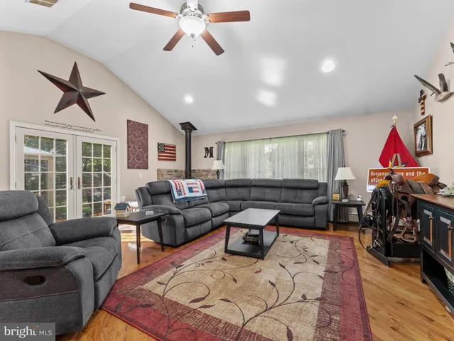 a living room with furniture or couch and a wooden floor