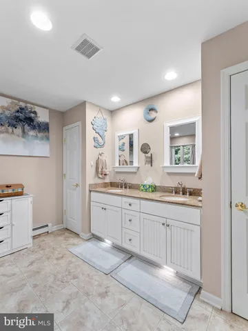 a spacious bathroom with a granite countertop sink a mirror and a