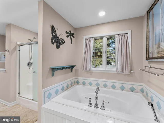 a bathroom with a tub and a shower