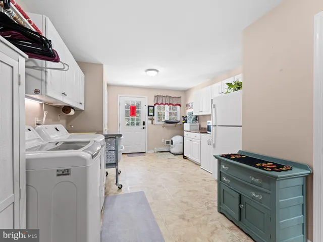 a kitchen with refrigerator and cabinets