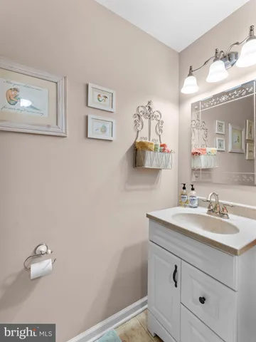 a bathroom with a sink a mirror and a vanity