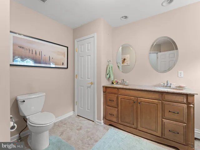 a bathroom with a toilet a sink and a mirror