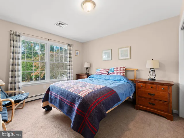 a spacious bedroom with a bed and a couch