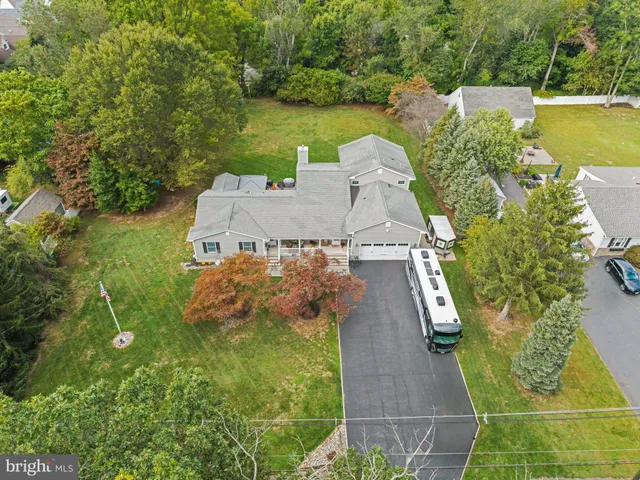 an aerial view of a house with swimming pool and garden view