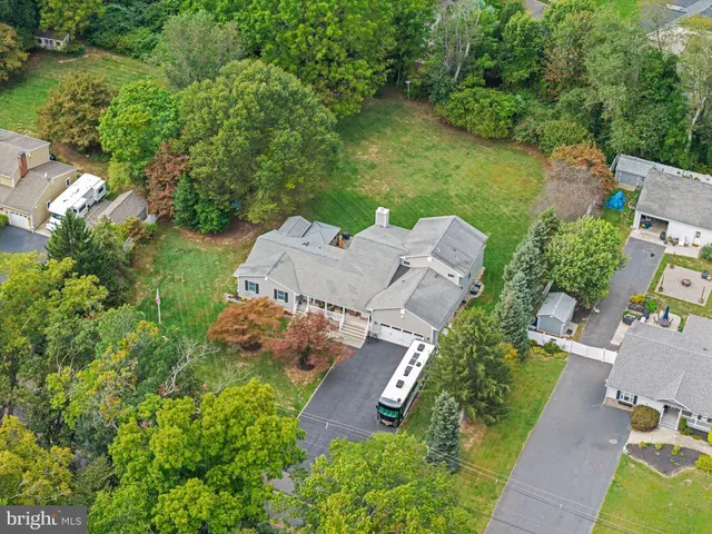 an aerial view of a house with garden space and a lake view