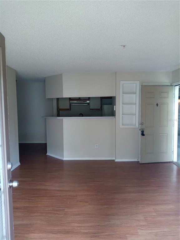 216 Afton Square, Unit 208 Altamonte Springs, FL 32714 - Photo 11 of 19 a view of an empty room with wooden floor