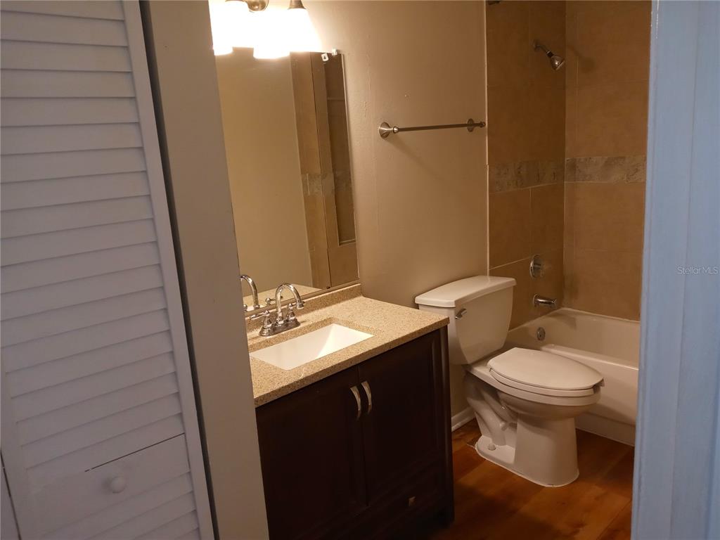 216 Afton Square, Unit 208 Altamonte Springs, FL 32714 - Photo 9 of 19 a bathroom with a toilet sink and mirror