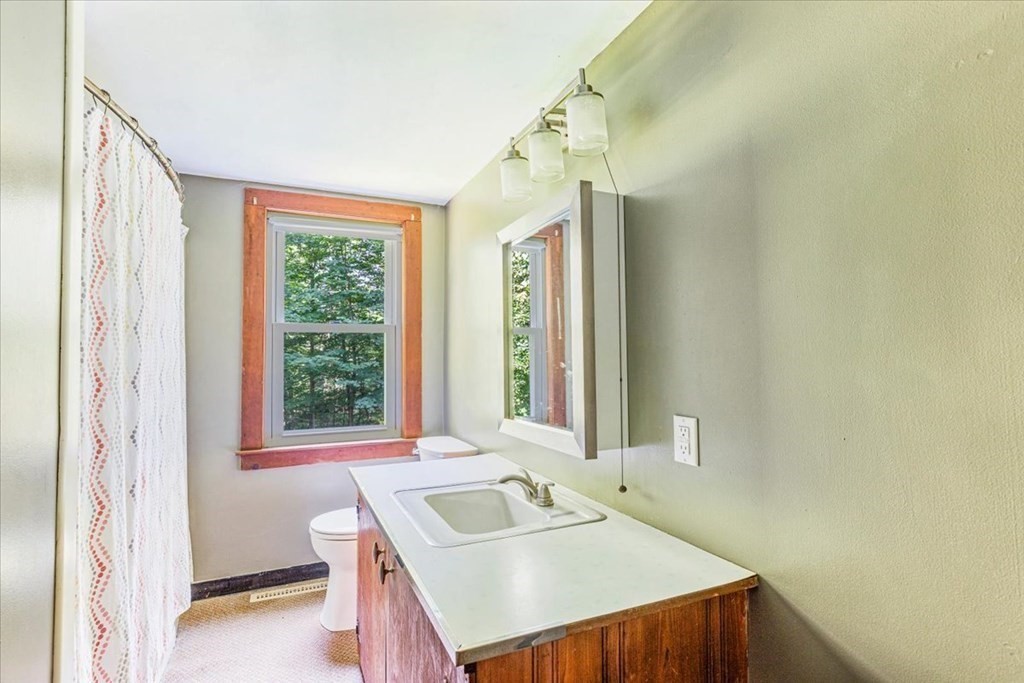 165 Summer Street Scituate, MA 02066 - Photo 16 of 22 a bathroom with a sink and a mirror