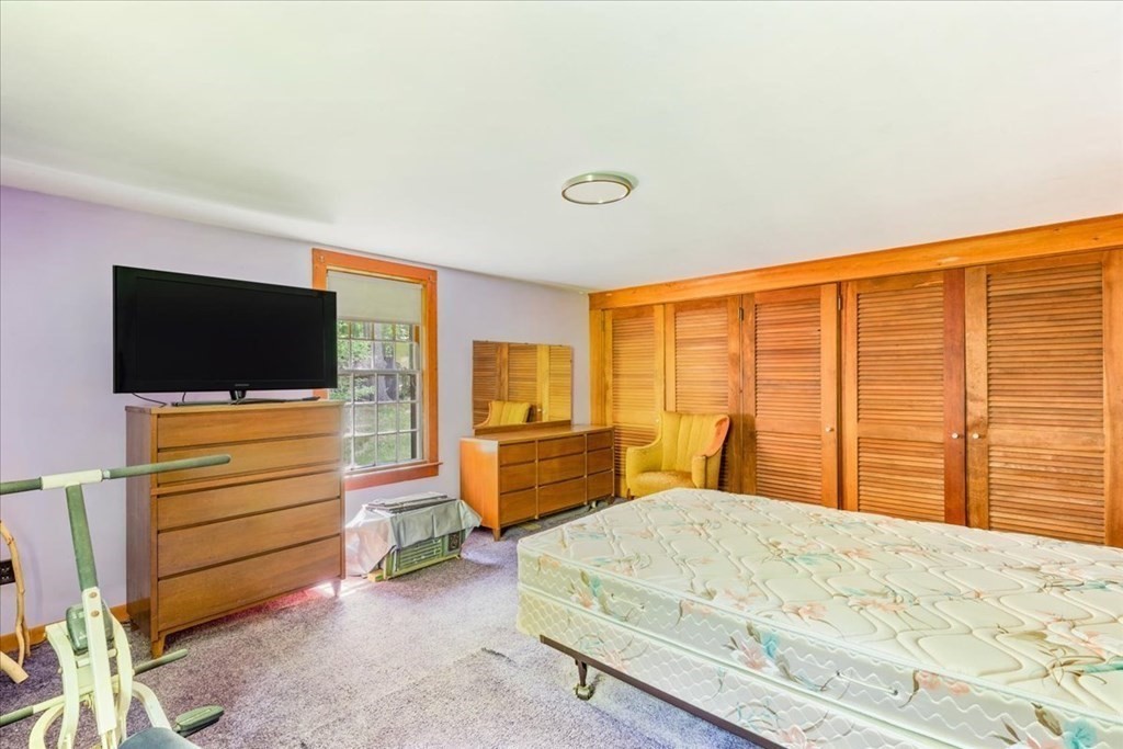 165 Summer Street Scituate, MA 02066 - Photo 18 of 22 a bedroom with a bed and flat screen tv