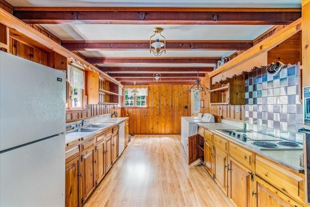 165 Summer Street Scituate, MA 02066 - Photo 9 of 22 a view of a kitchen with a sink and wooden floor