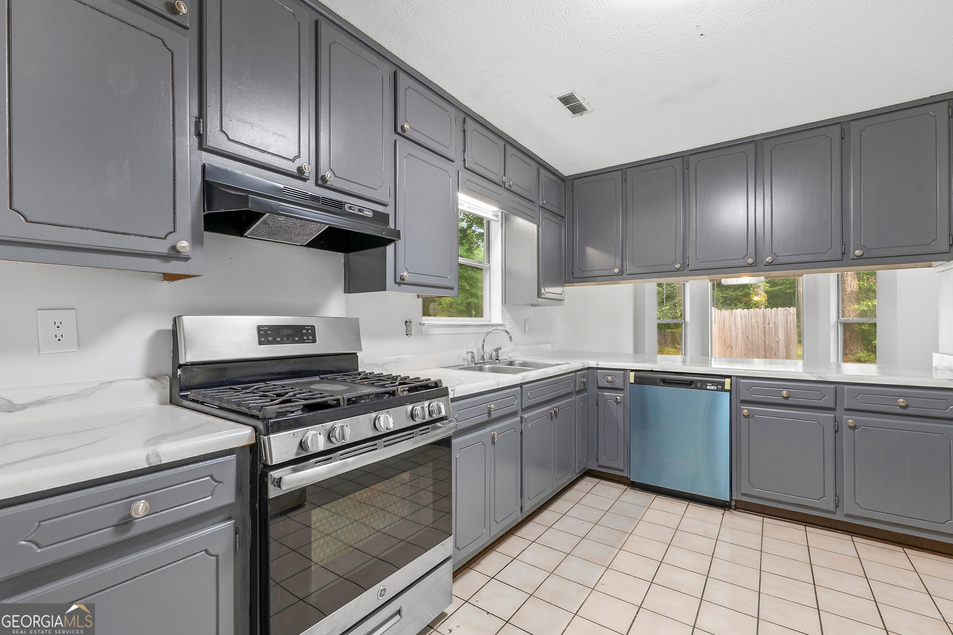 1328 Foxvale Drive Hampton, GA 30228 - Photo 3 of 27 a kitchen with stainless steel appliances granite countertop a sink a stove and cabinets