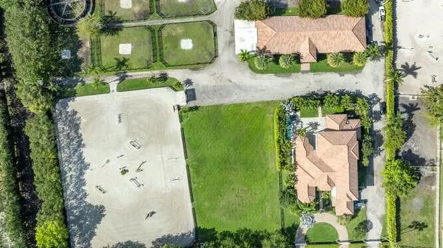 an aerial view of a house with a yard
