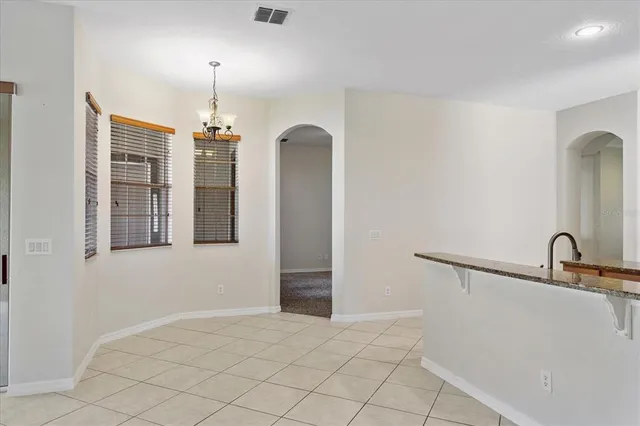 a view of a kitchen with a sink and chandelier