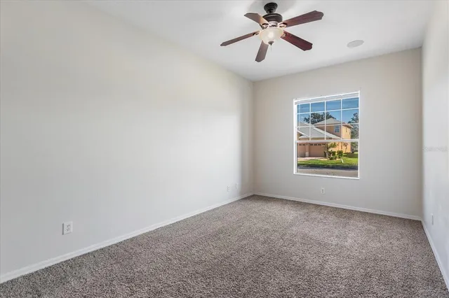 a view of room with window and ceiling fan