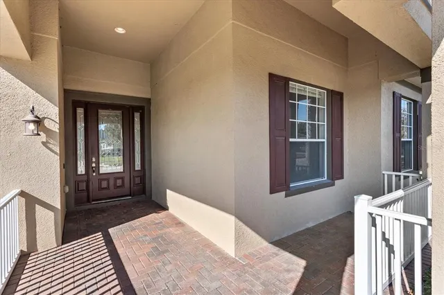 a view of a hallway with wooden floor and windows