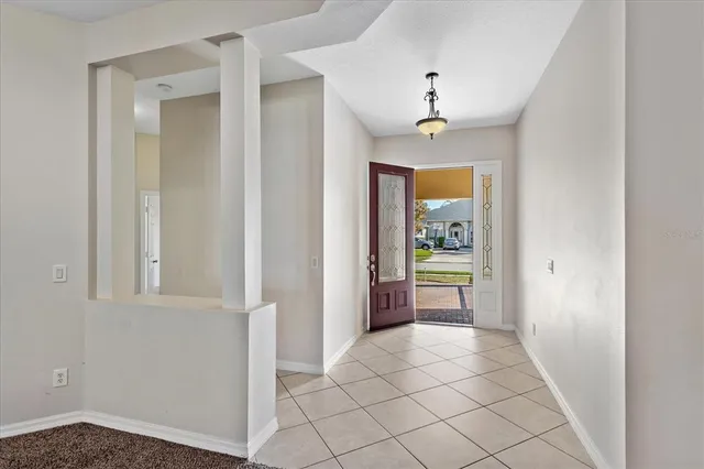 a view of an entryway with wooden floor and a kitchen