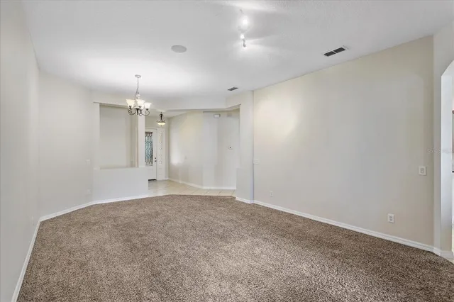 an empty room with a bathroom and a sink