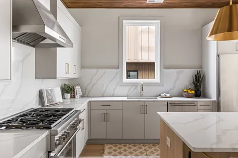 a kitchen with a sink stove and cabinets