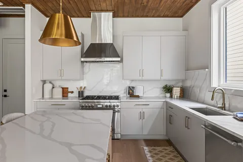 a kitchen with a sink a stove and cabinets
