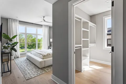 a bedroom with a bed and a large window