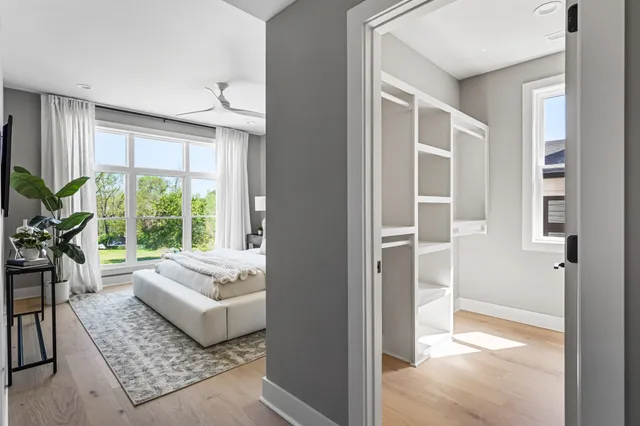 a bedroom with a bed and a large window