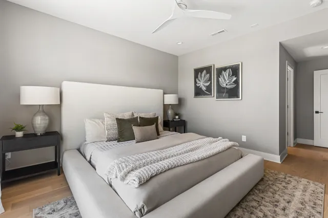 a bedroom with a bed and a flat screen tv