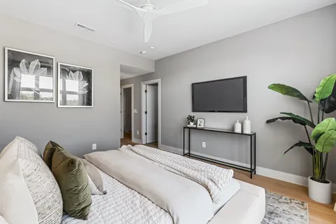 a bedroom with a bed and a television