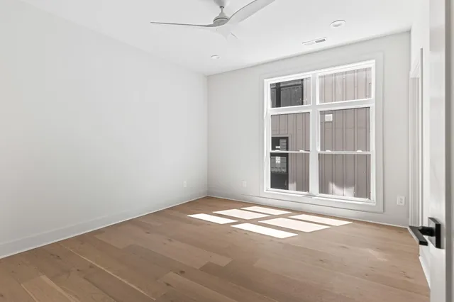 a view of a big room with wooden floor and closet