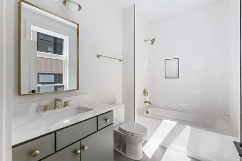 a living room with furniture and floor to ceiling windows