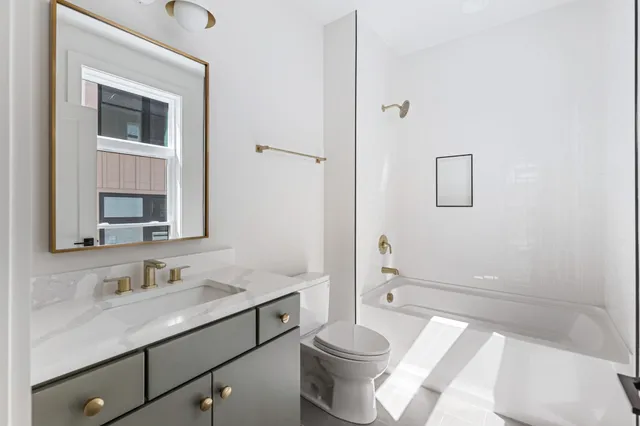 a living room with furniture and floor to ceiling windows