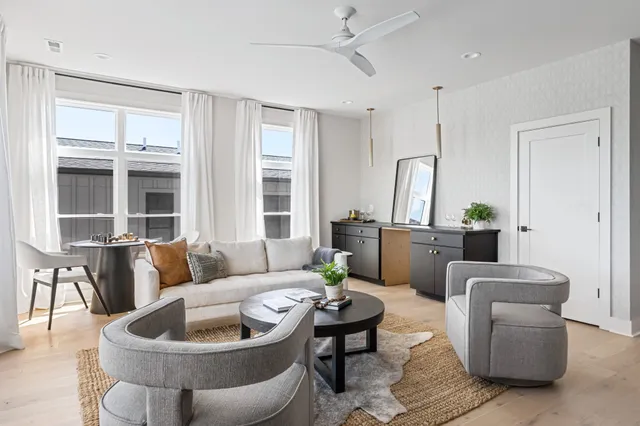 a living room with furniture and potted plant