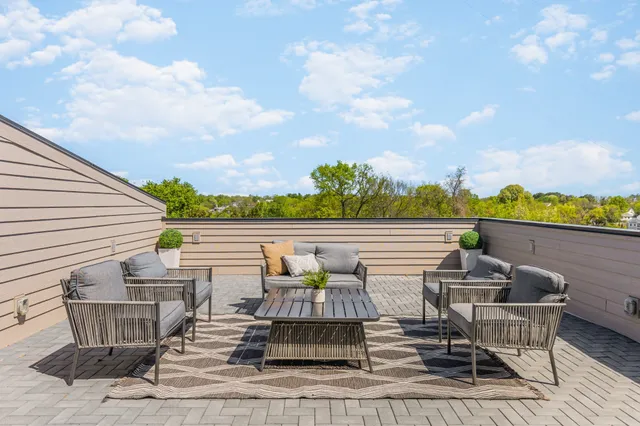 a view of a big building with a big yard and large trees