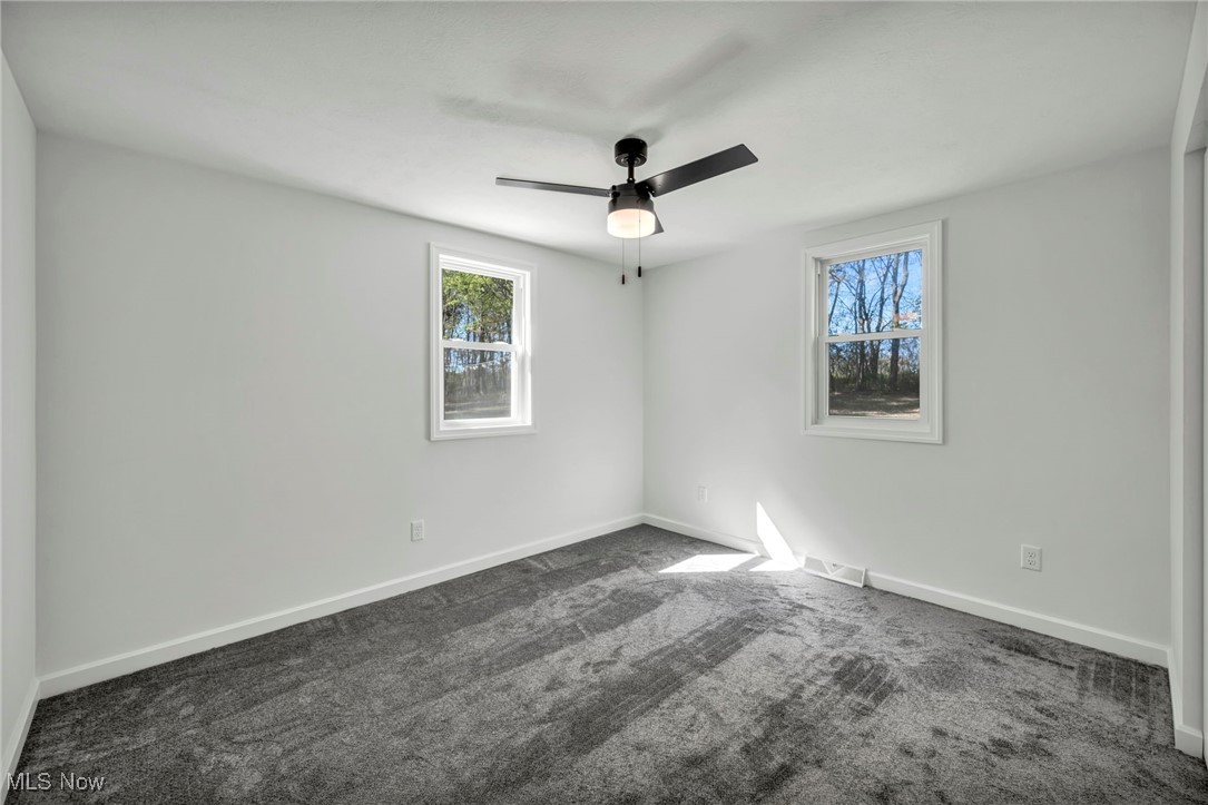 43575 Cream Ridge Road Lisbon, OH 44432 - Photo 27 of 50 Empty room featuring dark colored carpet and ceiling fan