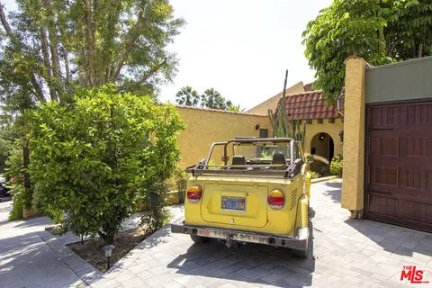 a utility room with dryer and trees