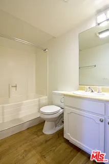 a bathroom with a toilet a sink and bathtub