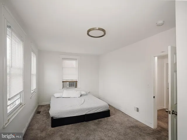 a bedroom with a bed and window