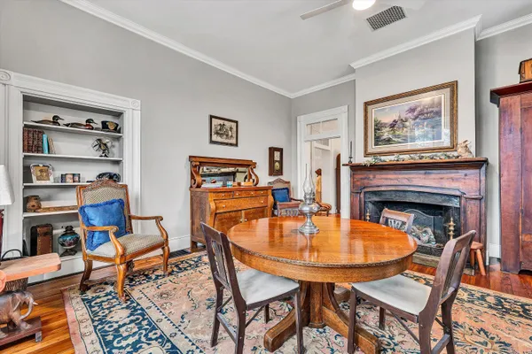a room with wooden floor and furniture
