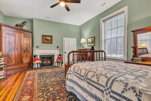 a bedroom with a bed flat screen tv and a window