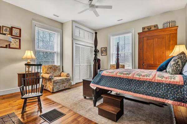 a view of a bedroom with furniture and a window