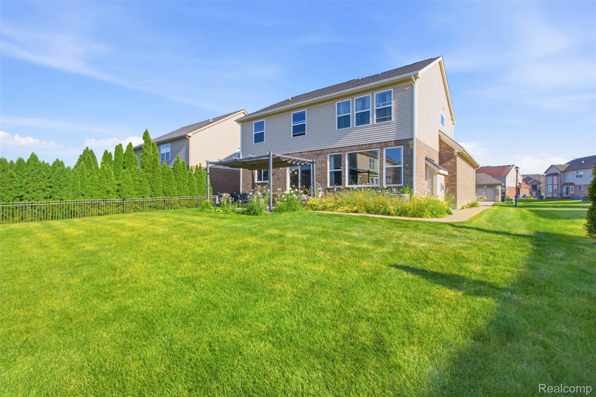 5085 Ridge Lane Warren, MI 48092 - Photo 29 of 29 Expansive green lawn with a two-story residence featuring brick and siding exterior
