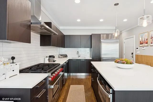 a kitchen with a stove a sink and a refrigerator