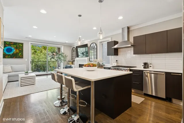 a kitchen with stainless steel appliances a sink stove and refrigerator
