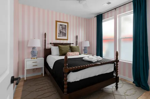 a bedroom with a bed and a window
