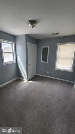 a view of empty room with windows