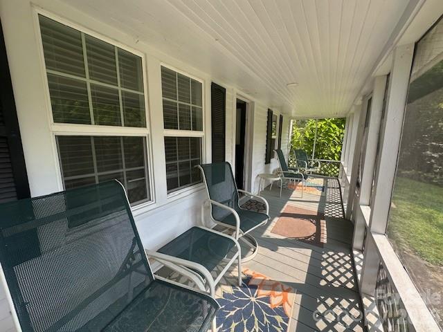 10 Chigger Ridge Road Sylva, NC 28779 - Photo 16 of 22 a view of a patio with table and chairs with wooden floor and fence