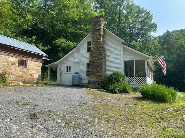 10 Chigger Ridge Road Sylva, NC 28779 - Photo 18 of 22 a view of a house with a yard and plants